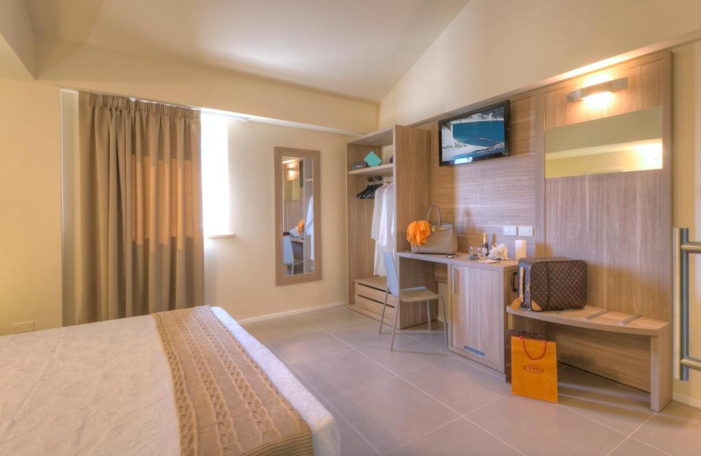 Postel nebo postele na pokoji v ubytování Palazzo Ruschioni Boutique Hotel