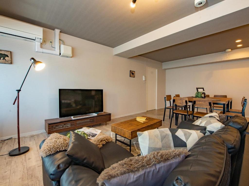 a living room with a couch and a flat screen tv at JOW2 Inn / Vacation STAY 81855 in Sapporo