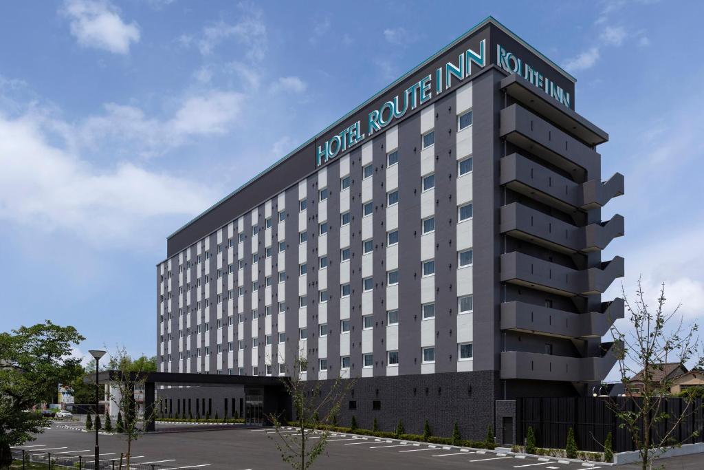 a building with a sign on the top of it at Hotel Route-Inn Yonago in Yonago