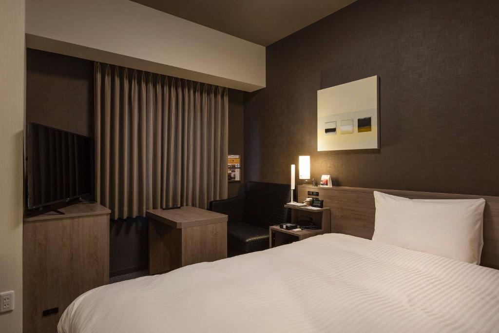 Postel nebo postele na pokoji v ubytování Hotel Route-Inn Yonago