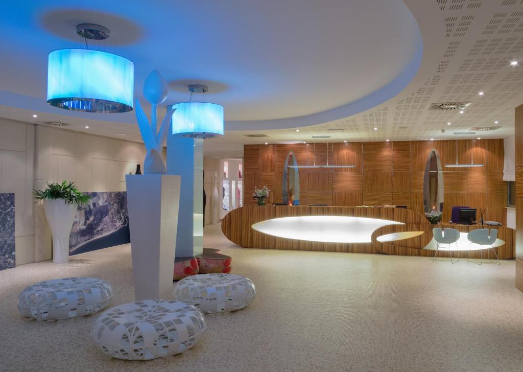 - un hall d'accueil avec une grande baignoire et des lumières bleues dans l'établissement Bibione Palace Spa Hotel, à Bibione