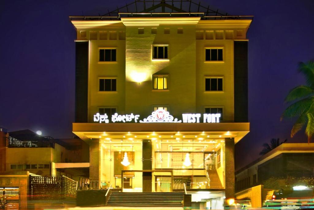 a building with a sign on it at night at WEST FORT HOTEL in Bangalore