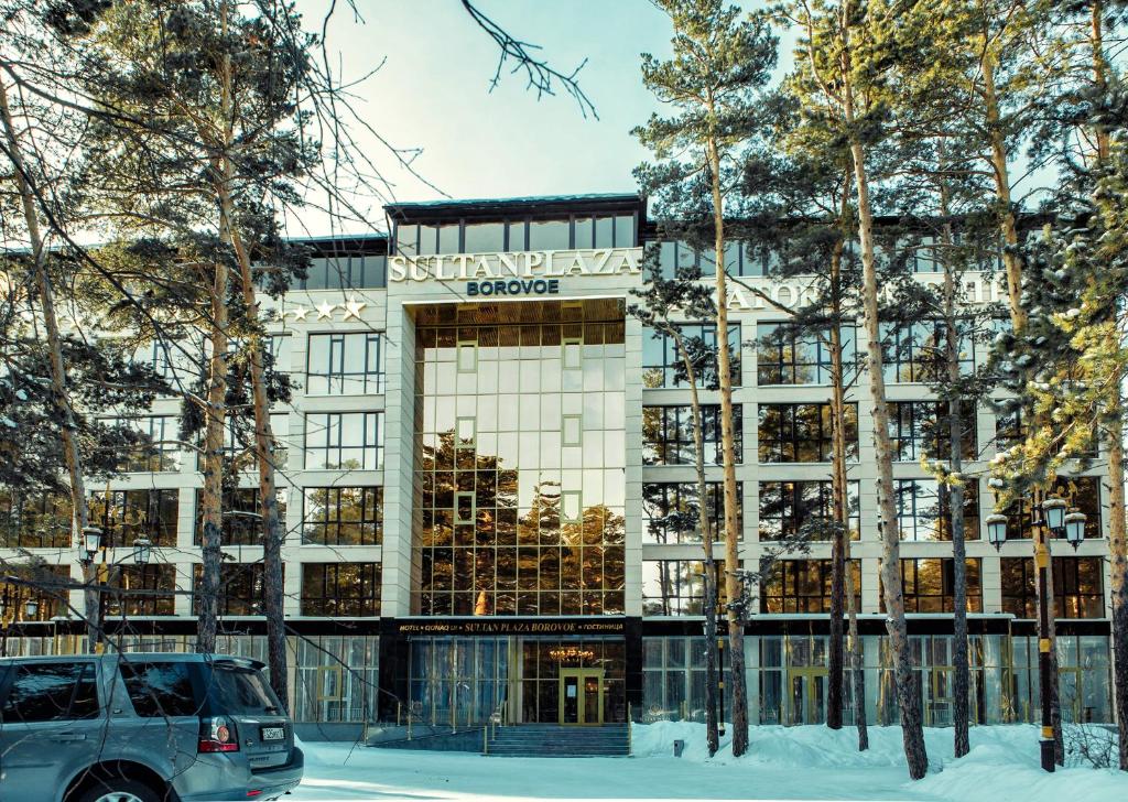 a suv parked in front of a building at SULTAN PLAZA Borovoe in Borovoye