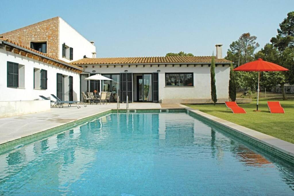 a swimming pool in front of a house at Son Paparra in Montuiri