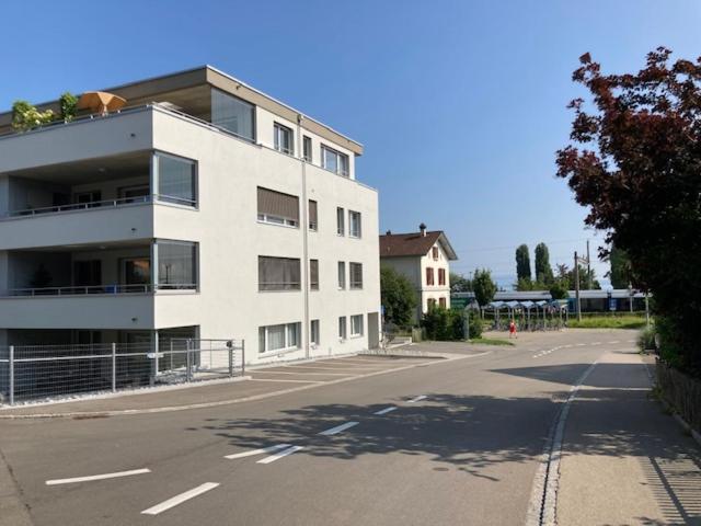 a large white building on the side of a street at Arnold's Neues Bahnhöfli in Uttwil