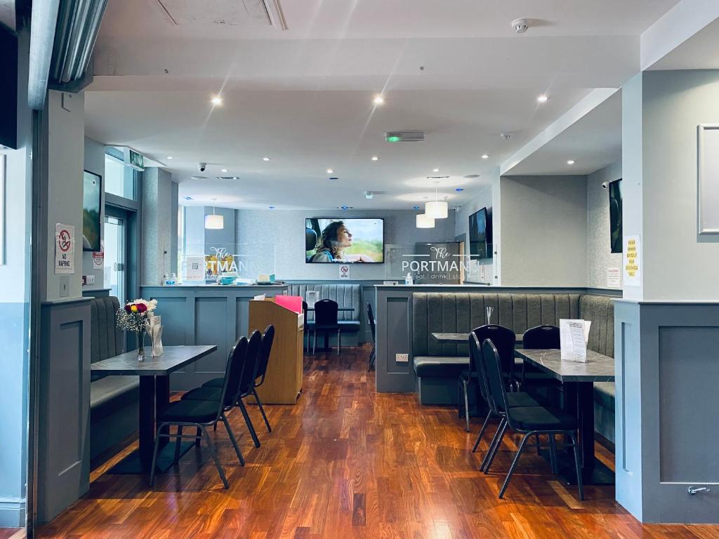 a restaurant with tables and chairs and a bar at The Portmann Hotel in Kilmarnock