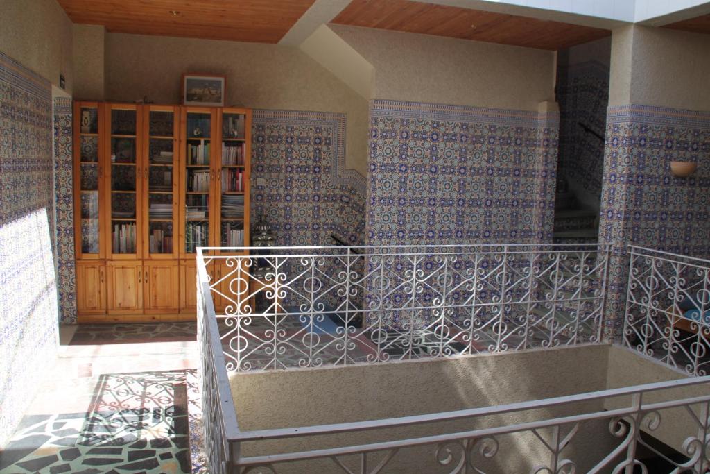 a room with a balcony with blue and white tiles at Riad Les Chtis D'Agadir in Agadir