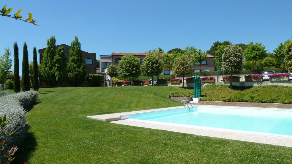 a swimming pool in the middle of a yard at Sangallo Park Hotel in Siena