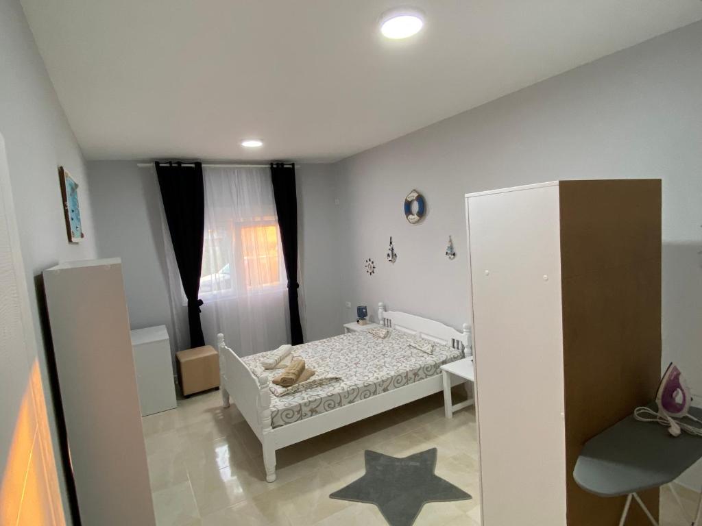 a small bedroom with a bed and stars on the floor at Kotor Apartman Green Sailor in Kotor