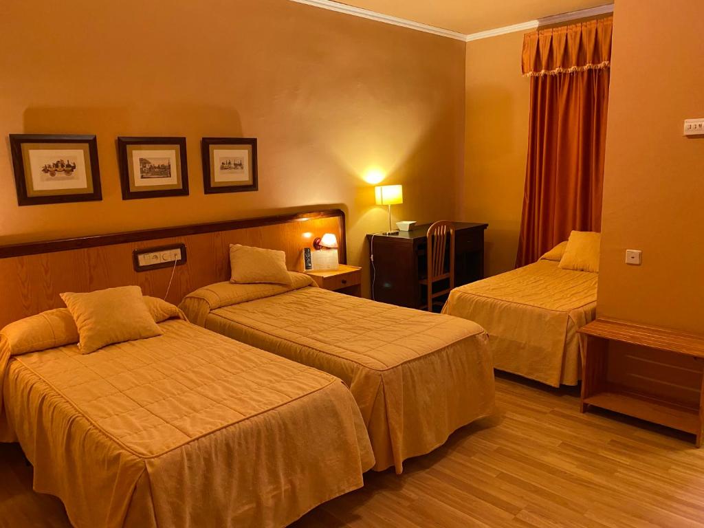 A bed or beds in a room at Hotel Don Juan