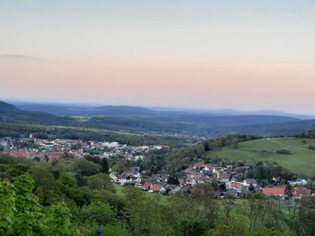 an aerial view of a town in the hills at Ferienhaus Rhönblick in Bischofsheim an der Rhön