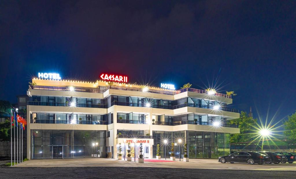 Un bâtiment avec un panneau de néon en haut. dans l'établissement Hotel Caesar 2, à Kardjali