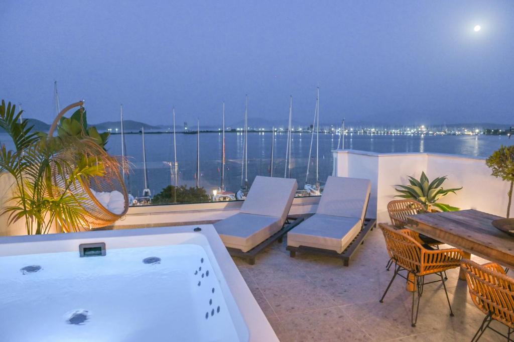 a hot tub on a balcony with a view of the water at The Well View in Preveza