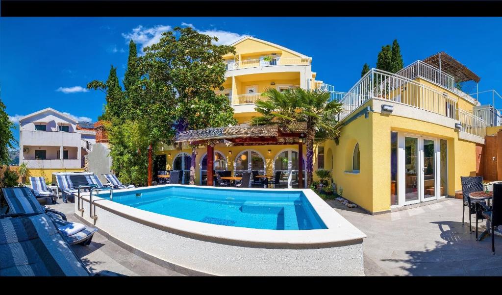 a swimming pool in front of a house at Castelletto in Cavtat