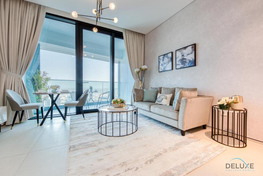 a living room with a couch and a table at Captivating 1BR at The Address Residences in JBR by Deluxe Holiday Homes in Dubai