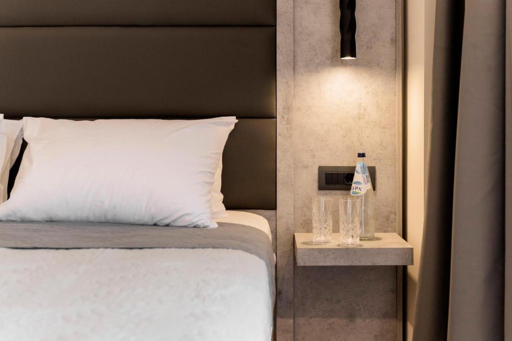 Posteľ alebo postele v izbe v ubytovaní Megusta Suites