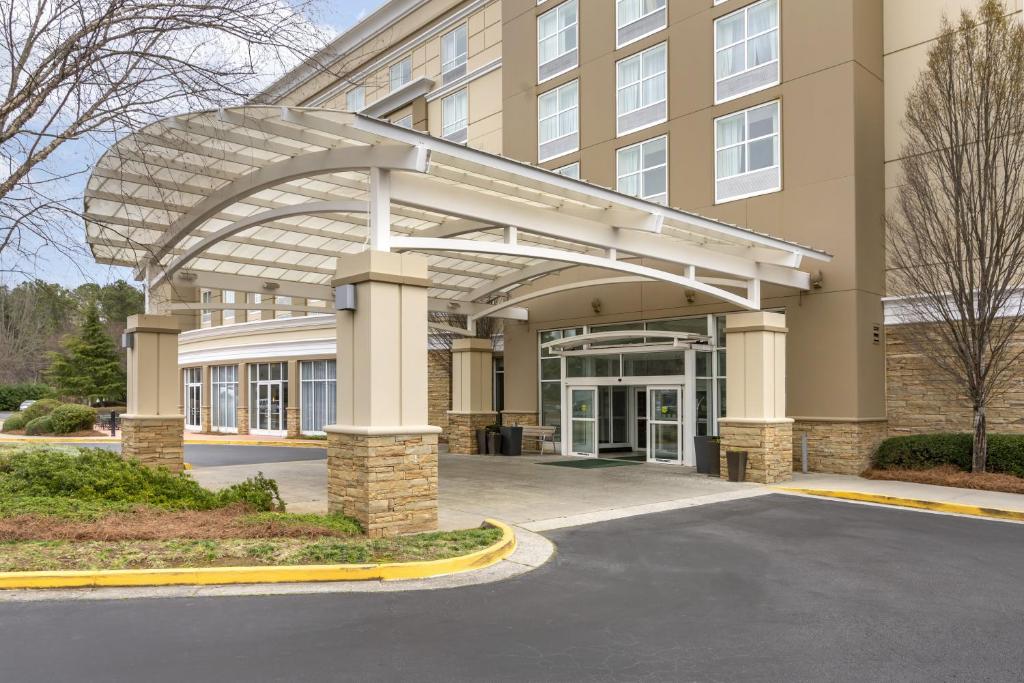 a large building with an archway in front of it at Holiday Inn Atlanta-Gas South Arena Area, an IHG Hotel in Duluth