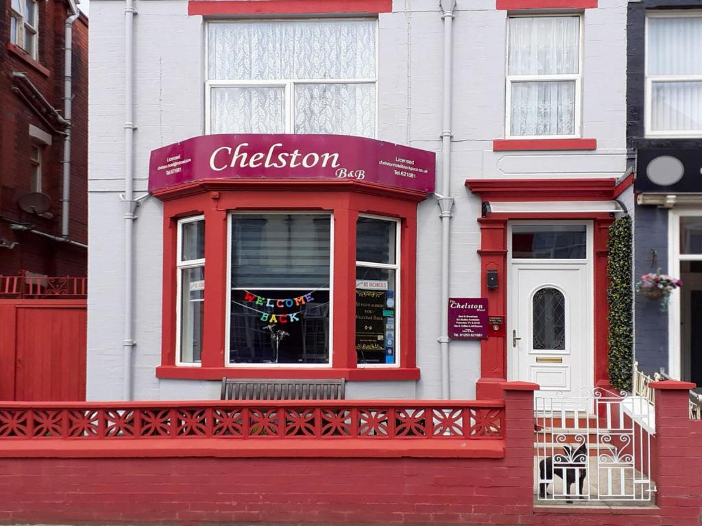 a red and white building with a window at The Chelston Bed and Breakfast in Blackpool