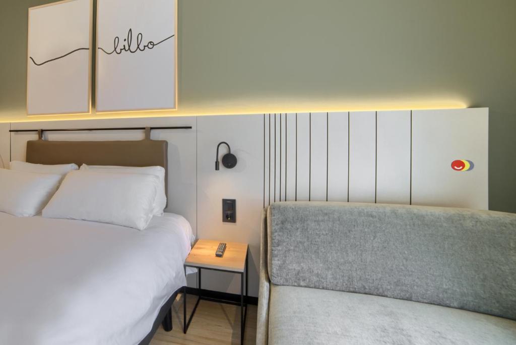 A bed or beds in a room at voco Bilbao - City by IHG