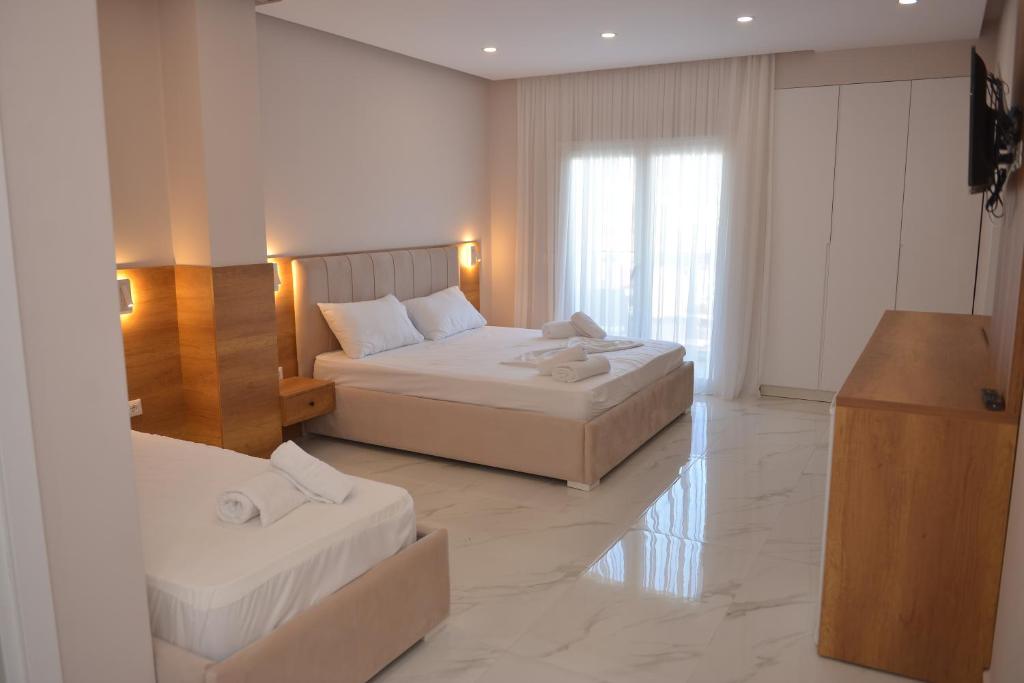 Postel nebo postele na pokoji v ubytování Hotel Margjokaj