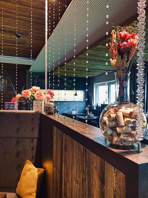 a lobby with a counter with a vase of flowers at Hotel Central in Gerlos