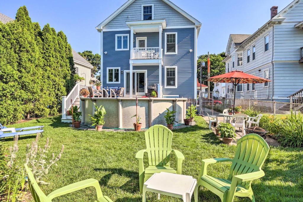 a yard with two chairs and an umbrella at New London Hideaway Near Beaches and Local Spots! in New London