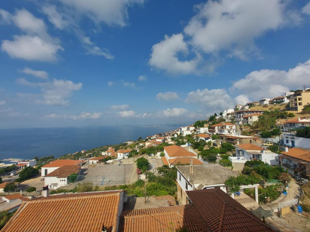 a view of a town with houses and the ocean at George's Apartment in Loutraki