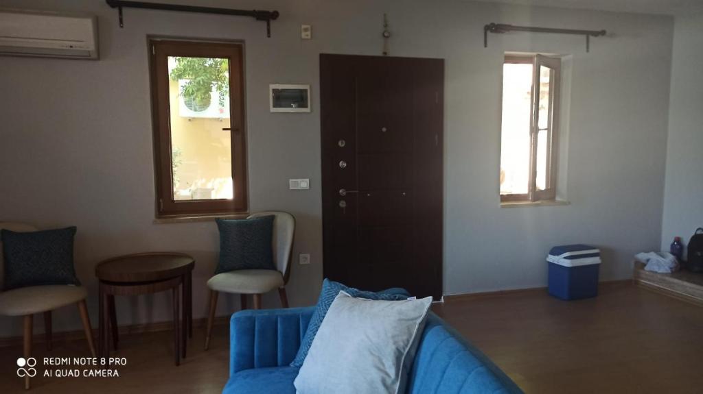 a living room with a blue couch and chairs at Riverside villas in Ortaca