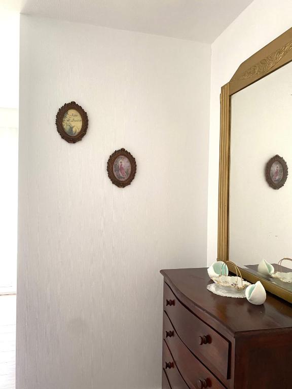 a bathroom with a dresser and a mirror on a wall at LE VIEUX MOULIN in Bouhet