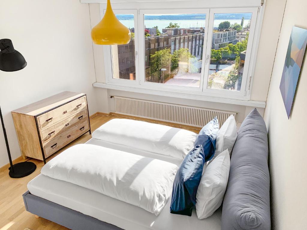 a living room with a couch and a window at ARISER - Lake View Business Apartment in Zug