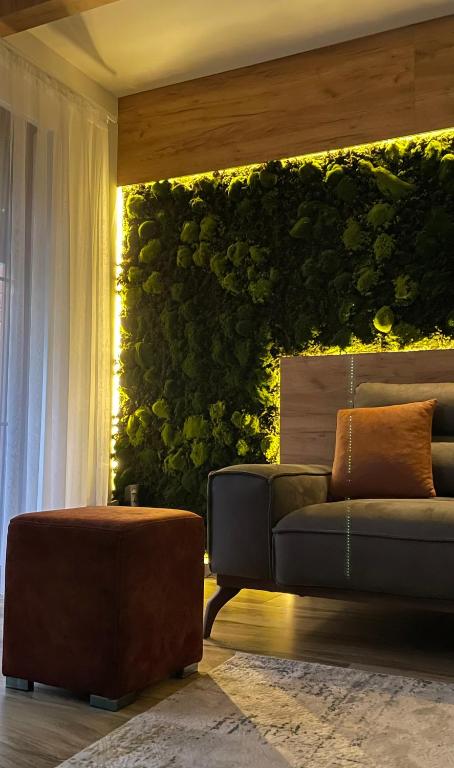 a living room with a couch and a green wall at Villa Breza Brezovice in Brezovica