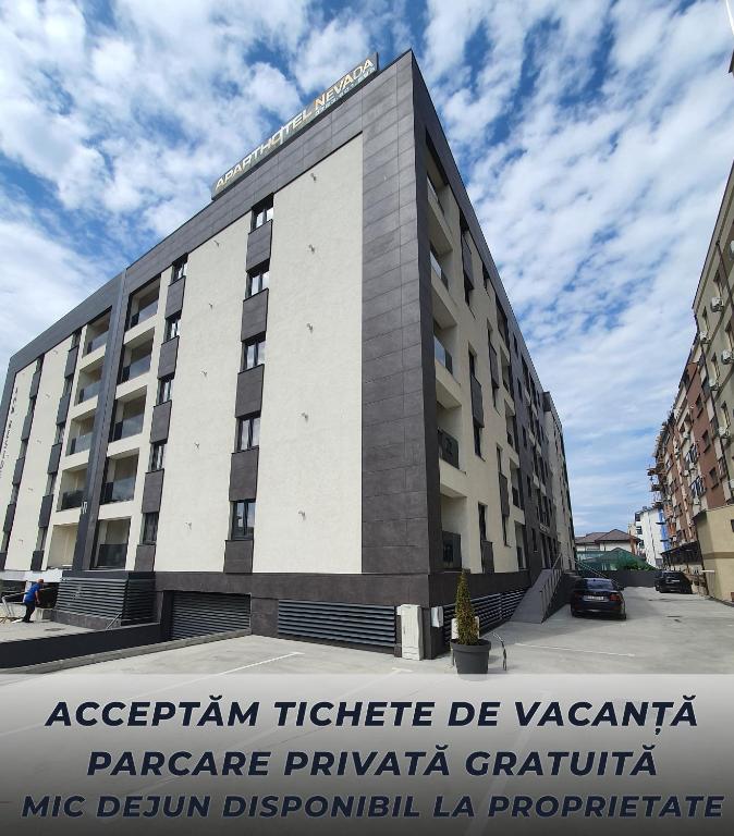 a building with a sign in front of it at Aparthotel Nevada - Apartamente in Constanţa