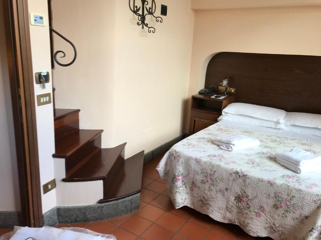 Postel nebo postele na pokoji v ubytování Hotel OKAPI
