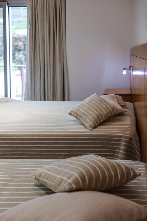 Postel nebo postele na pokoji v ubytování Hotel Comodoro