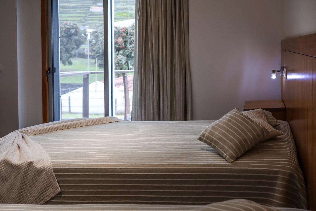 Postel nebo postele na pokoji v ubytování Hotel Comodoro