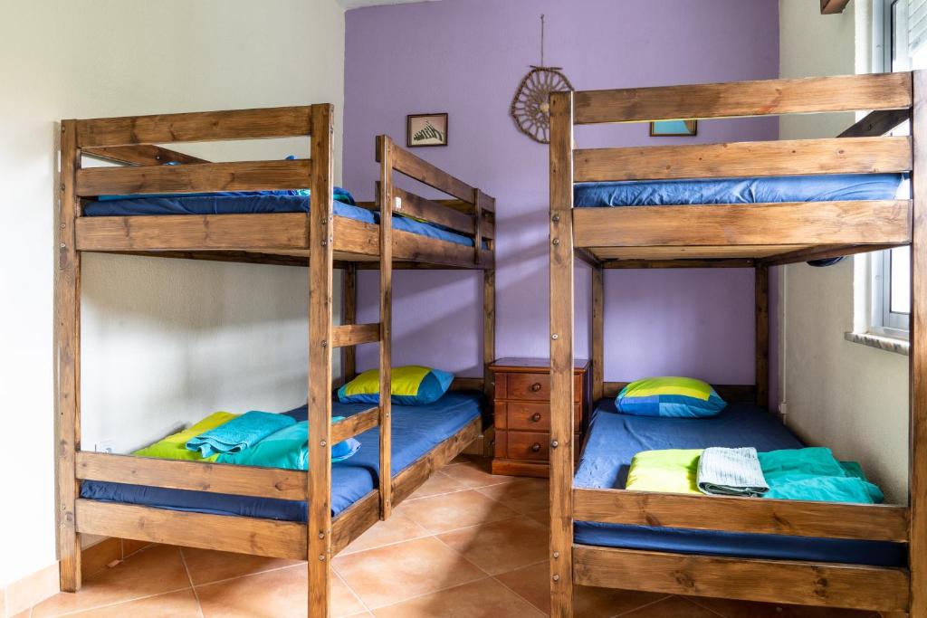 a bedroom with two bunk beds in a house at Natural Mystic Hostel in Costa da Caparica