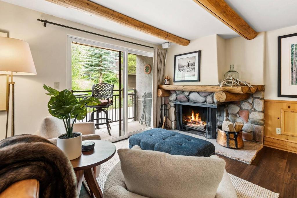 a living room with a fireplace and a couch at 700 Monarch 201 in Aspen