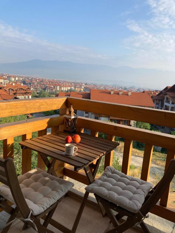 a wooden table and two chairs on a balcony at Mirabell Studio Bansko - Amazing view & fireplace in Bansko