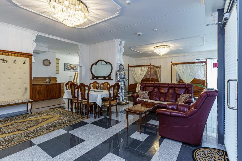 a living room with a couch and a table and chairs at Apartments near Old Town in Tallinn