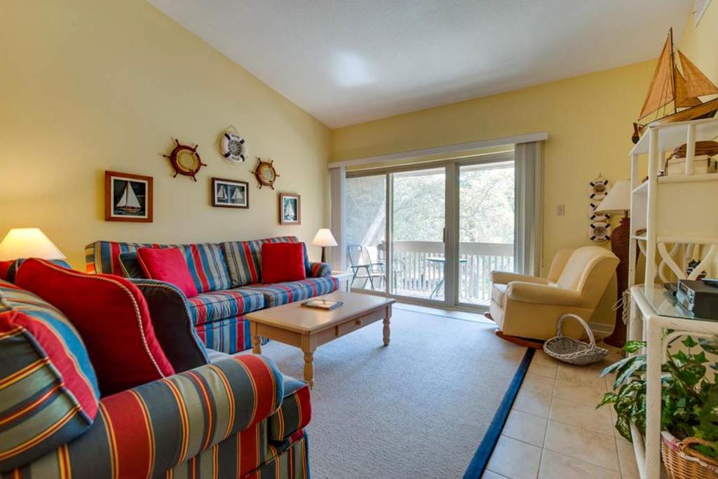 a living room with a couch and a table at Bluff Villas 1673 in Hilton Head Island