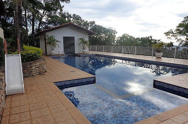 a swimming pool in front of a house at Casa na Montanha (Serra Negra) in Serra Negra