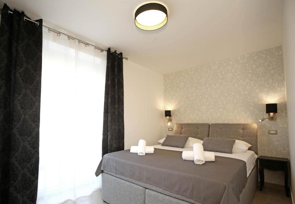 a bedroom with two beds and a large window at Apartment Tonka in Šibenik
