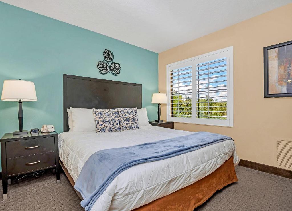 a bedroom with a large bed and a window at Near Disney - 1 Bed King Suite - Pool and Hot Tub in Orlando