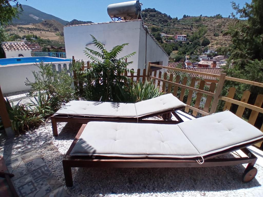 a couple of lounge chairs on a patio at Casa Cueva “La Estrella” in Granada