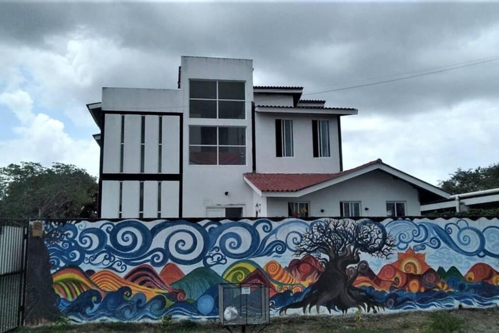 a wall with a painting on it in front of a building at CASA VACACIONAL DE PLAYA in Nueva Gorgona