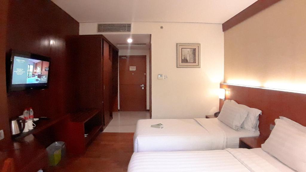 Postel nebo postele na pokoji v ubytování Oak Tree Emerald Hotel & Coventions Semarang