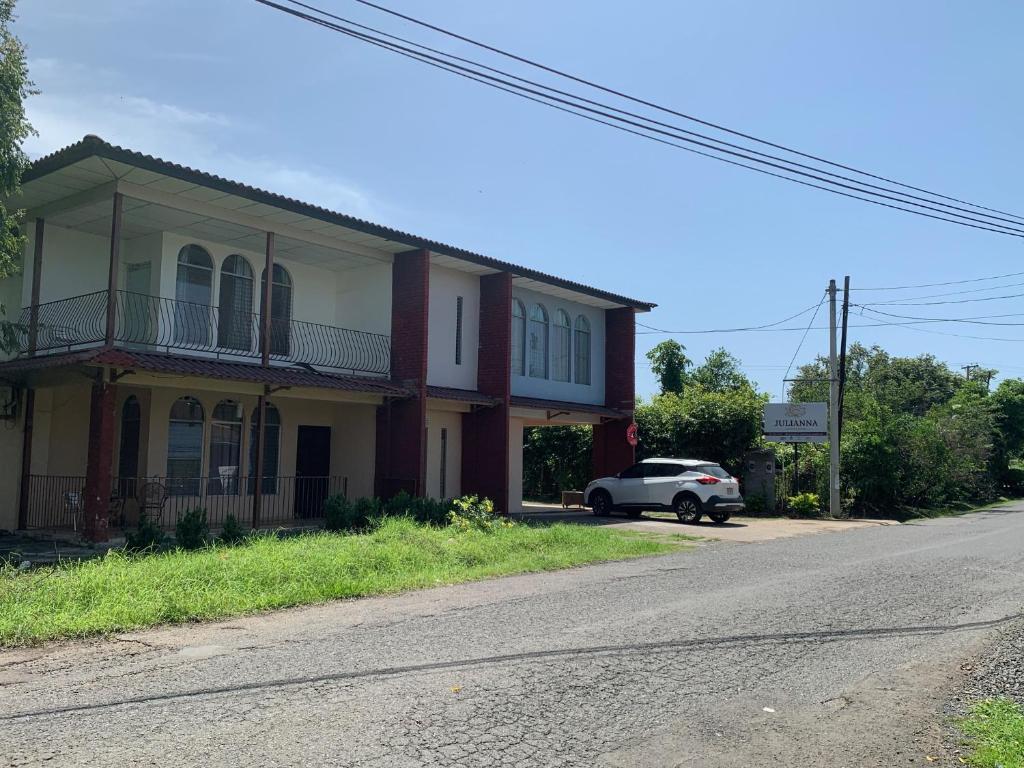 a white car parked in front of a house at Julianna Country House in Las Tablas