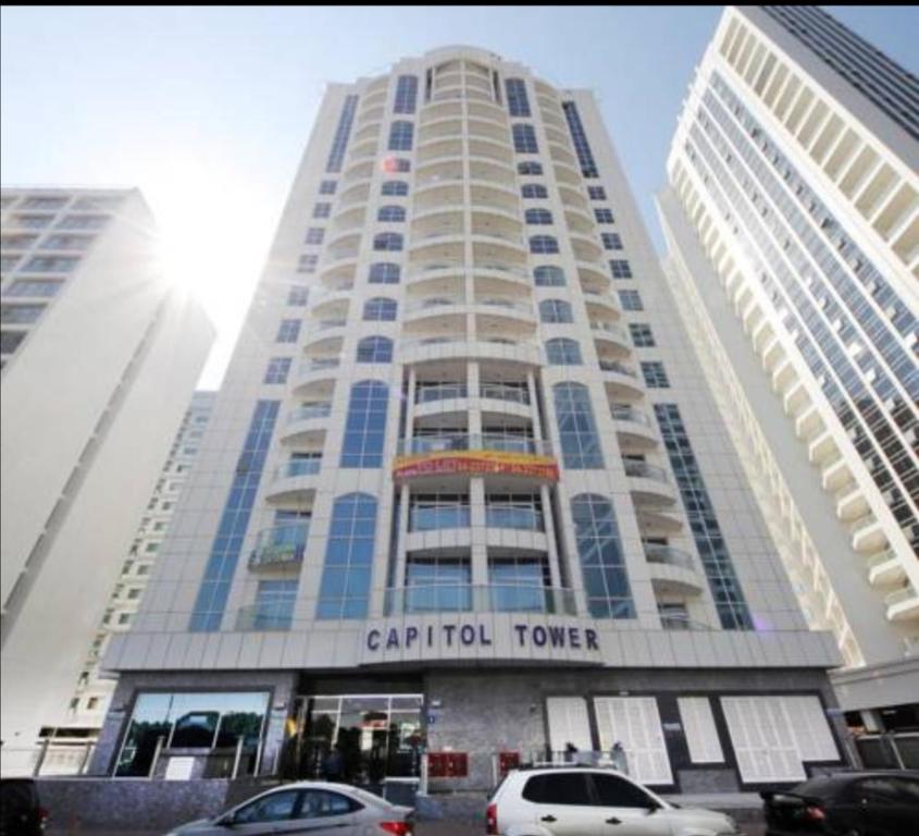 a tall building with cars parked in front of it at Amazing Homestay Partition Room for 1 in Dubai