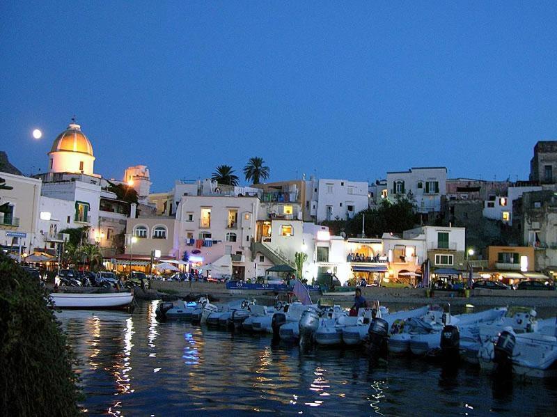 a group of boats docked in a harbor at night at Casa Nenna, centro di Forio in Ischia