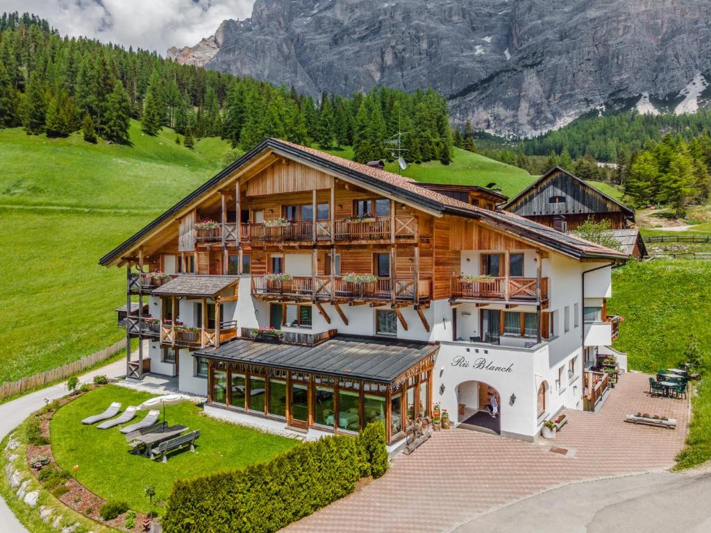 an aerial view of a house in the mountains at Hotel Ciasa Rü Blanch in San Cassiano